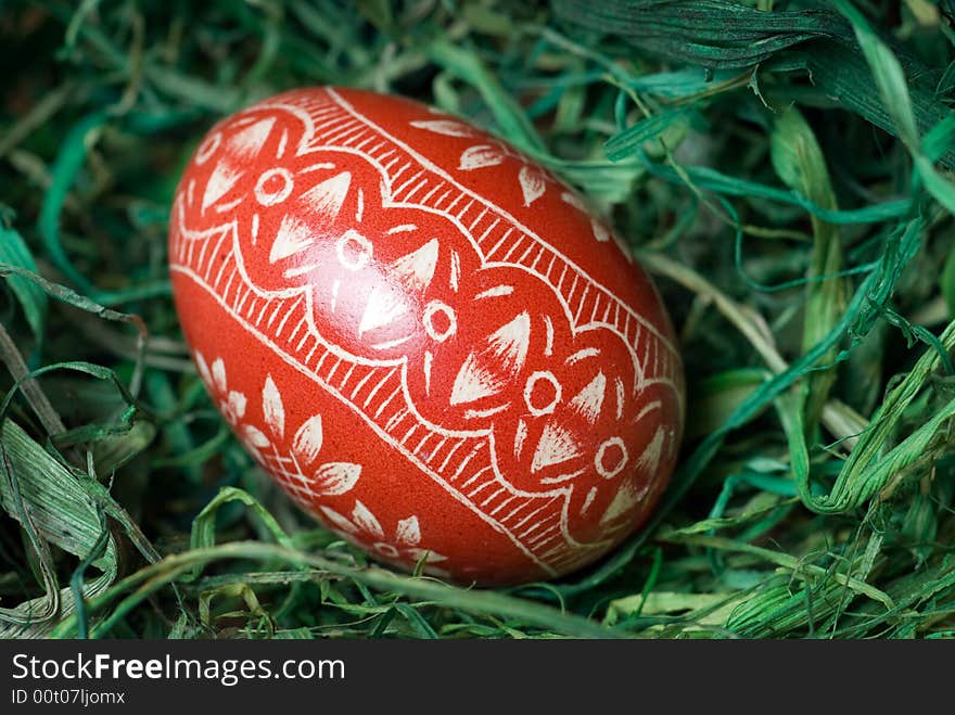 Handmade easter egg on the green hay. Shallow depth of field. Handmade easter egg on the green hay. Shallow depth of field.