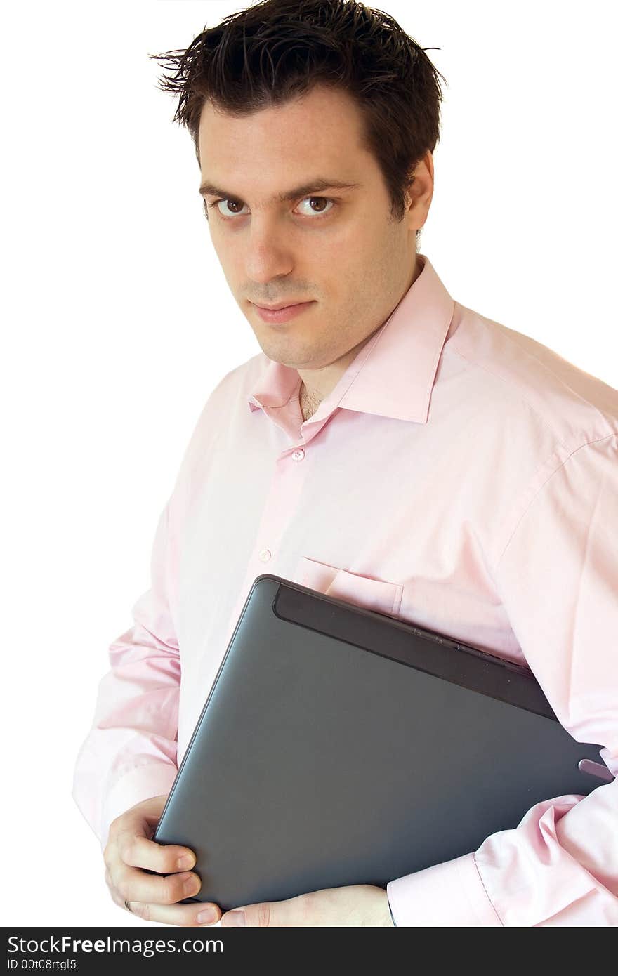 A man, carrying a laptop computer under his arm, smiling. A man, carrying a laptop computer under his arm, smiling