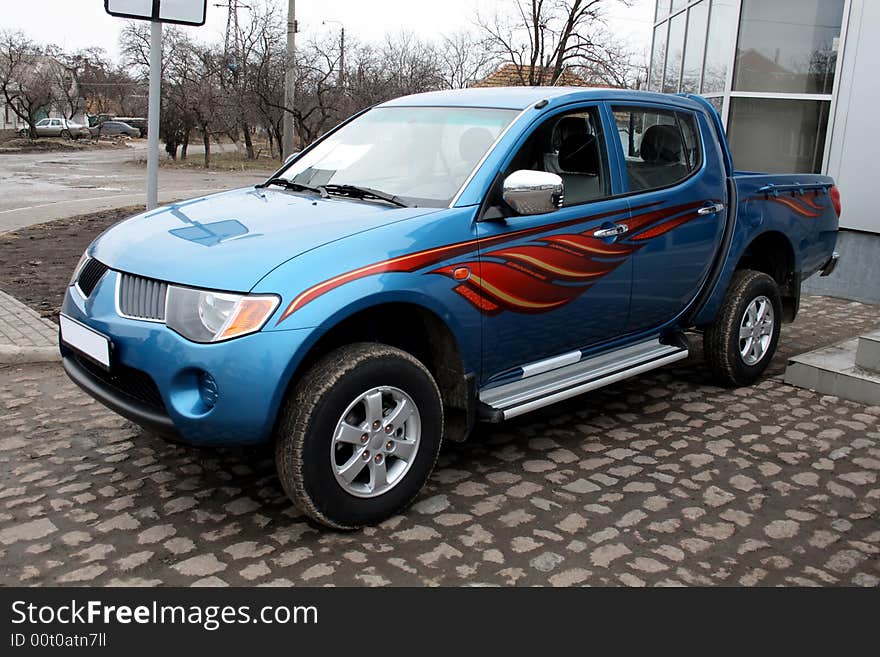 New blue pickup parked on stone pavement. New blue pickup parked on stone pavement