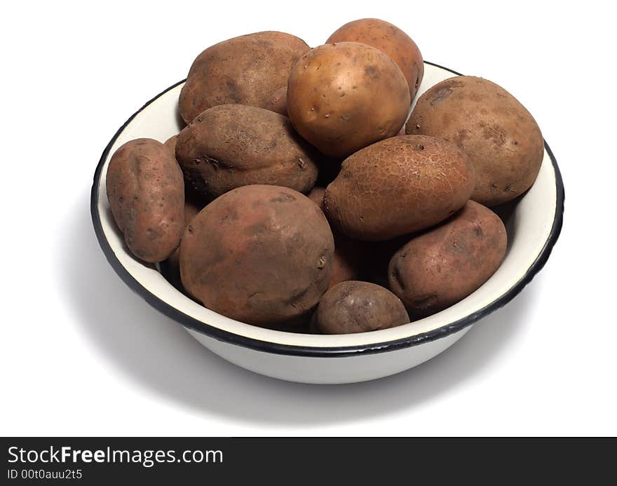 Bowl of raw organic potatoes isolated on white background