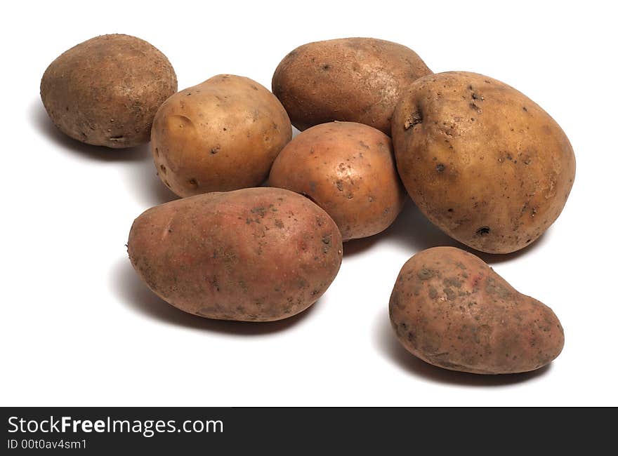 Several raw organic potatoes isolated on white background. Several raw organic potatoes isolated on white background