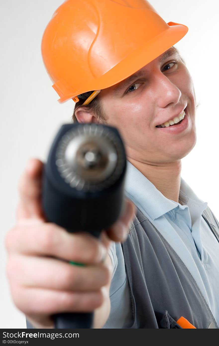 Smiling construction worker aim drill as a gun. Isolated on white. Smiling construction worker aim drill as a gun. Isolated on white.