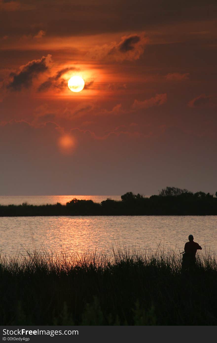 I saw this person fishing in the sound near Buxton, North Carolina on a summer evening. I saw this person fishing in the sound near Buxton, North Carolina on a summer evening.