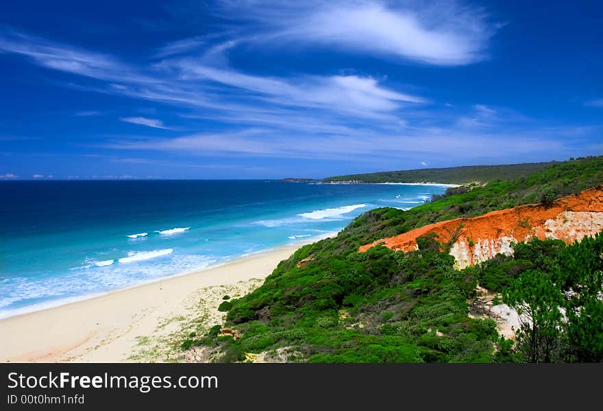 Vivid Red Cliffs on Unspoilt Beach