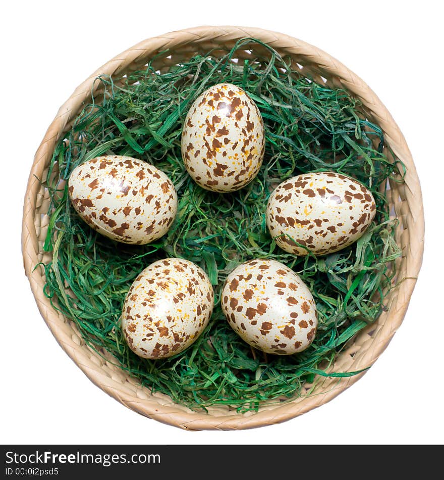 Basket with spotted eggs on the green hay. Clipping path included. Basket with spotted eggs on the green hay. Clipping path included.