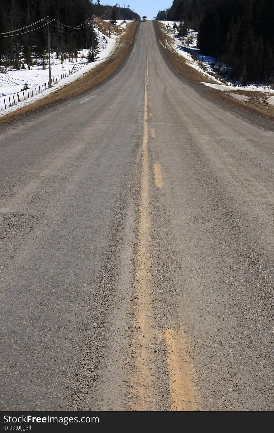 A prairie highway stretching of into the early spring. A prairie highway stretching of into the early spring