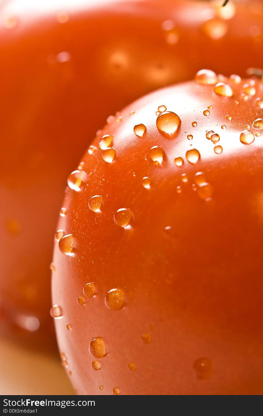 Fresh red ripe tomatoes with water drops shot with a macro lens. Fresh red ripe tomatoes with water drops shot with a macro lens