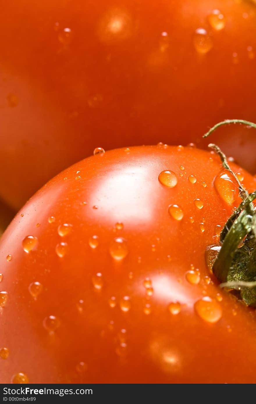 Fresh red ripe tomatoes with water drops shot with a macro lens. Fresh red ripe tomatoes with water drops shot with a macro lens