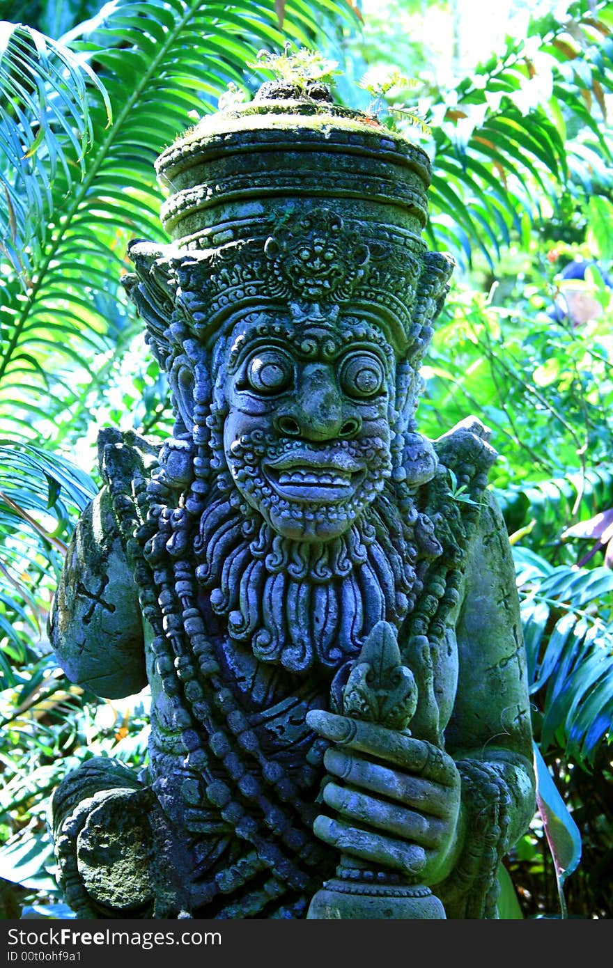 Religious statue in tropical garden