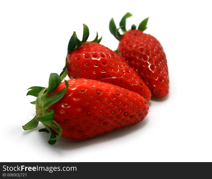 Three strawberries on a white background.