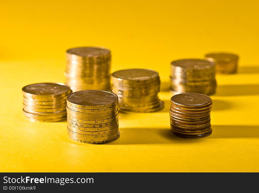 Money series: coins on the yellow background