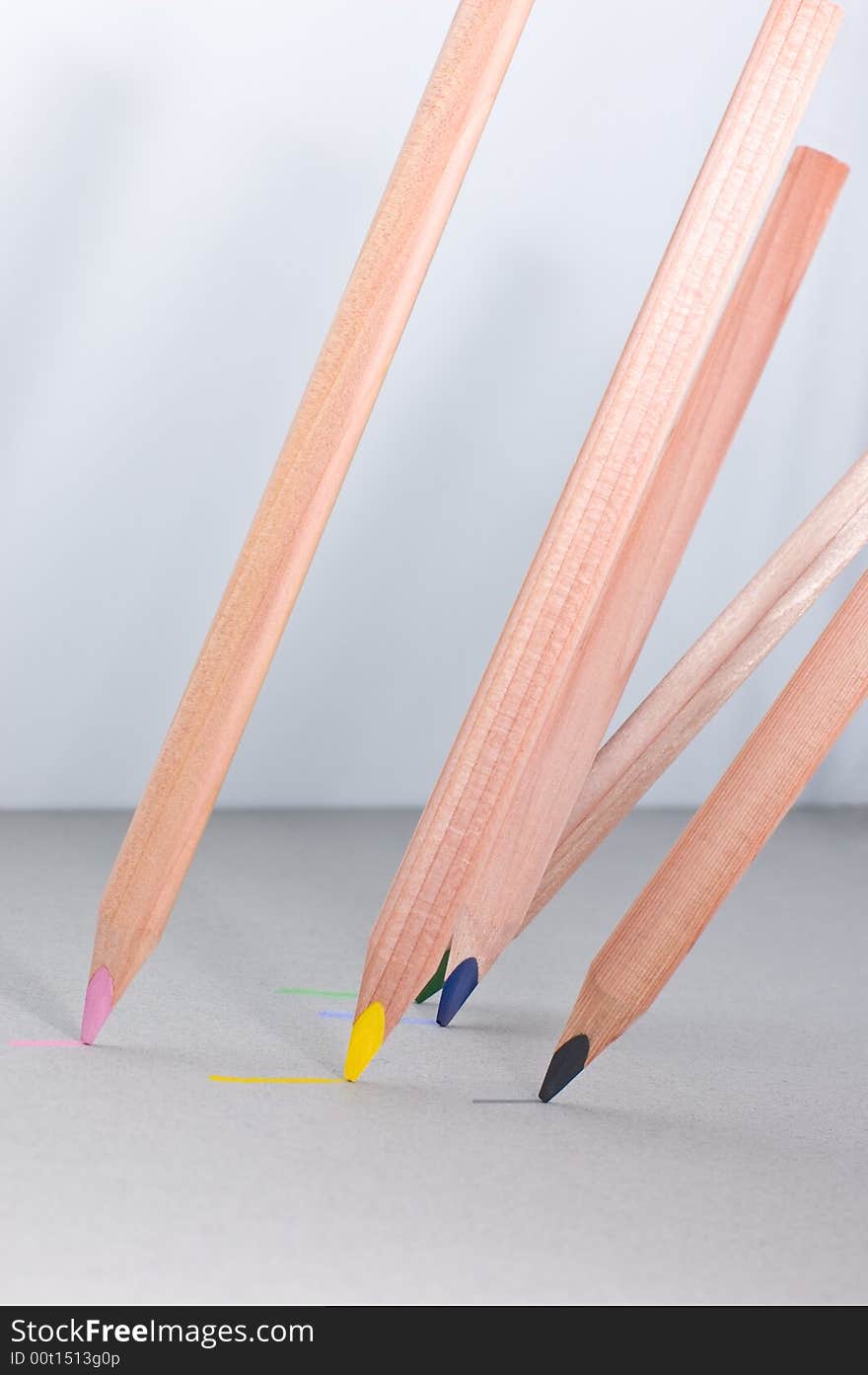 Multicoloured pencils on grey background