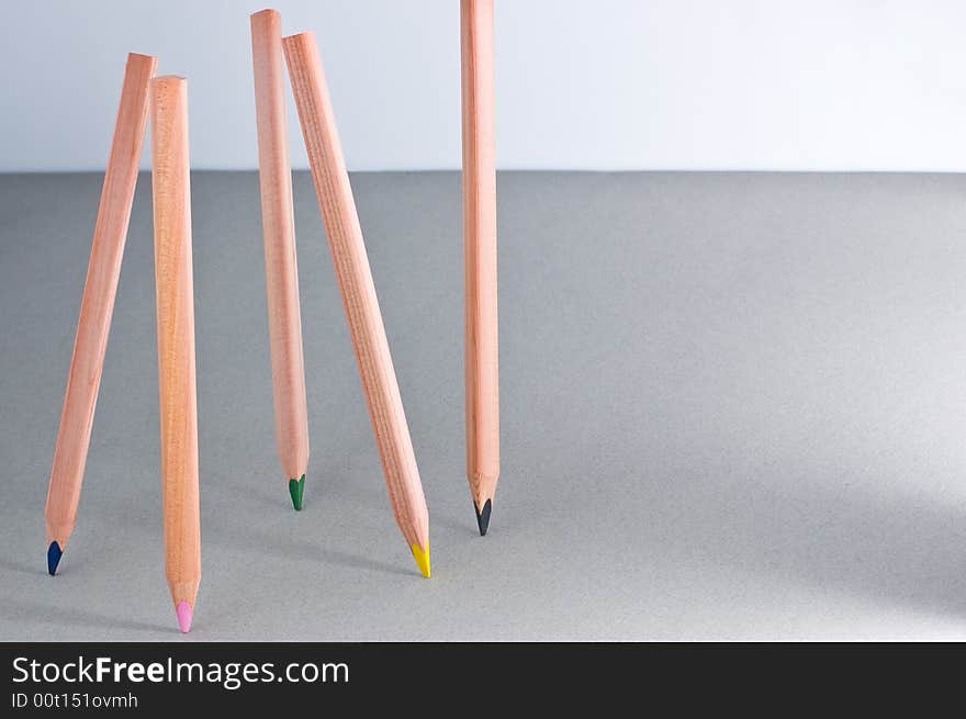 Multicoloured pencils on grey background