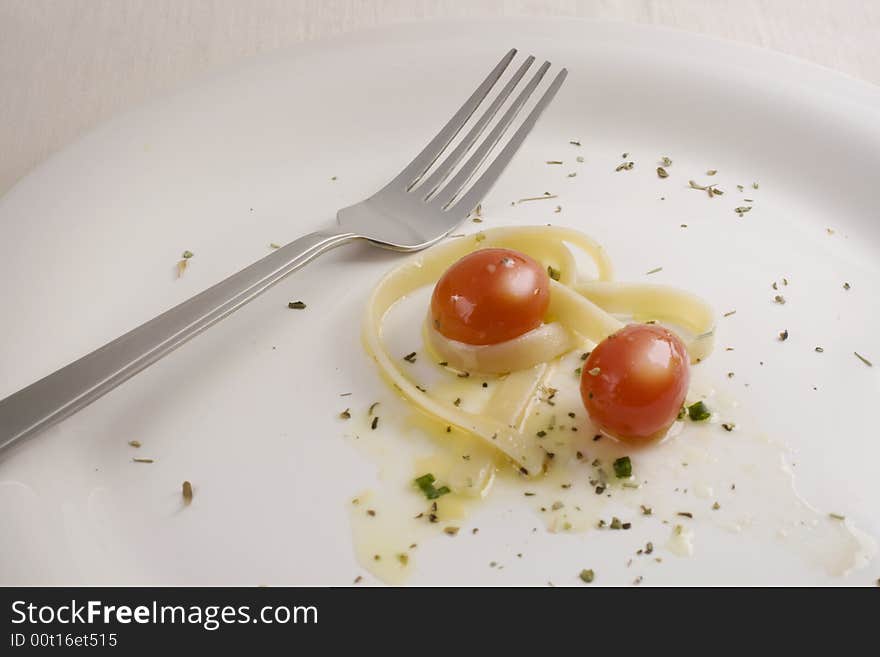 Plate with fetuccini and tomato. Plate with fetuccini and tomato