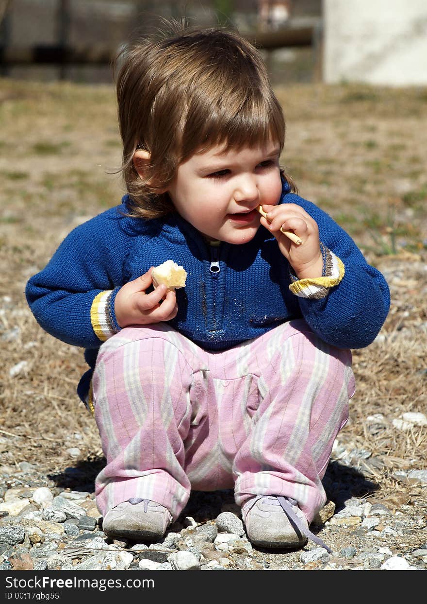 Baby eat a bread in the garden. Baby eat a bread in the garden