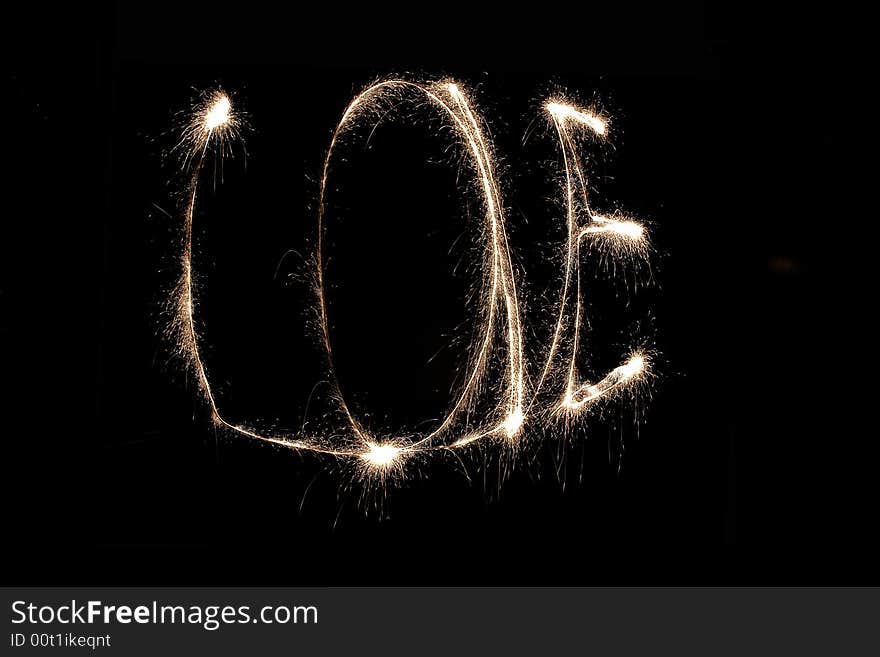 Word love written with sparkling fire on black background. Word love written with sparkling fire on black background