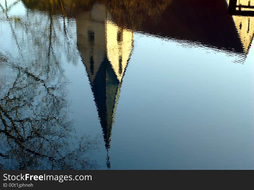 Reflection of Blaubeuren's conventual church in the Blautopf spring pond. Blaubeuren is located near Ulm, South-Germany. Reflection of Blaubeuren's conventual church in the Blautopf spring pond. Blaubeuren is located near Ulm, South-Germany.