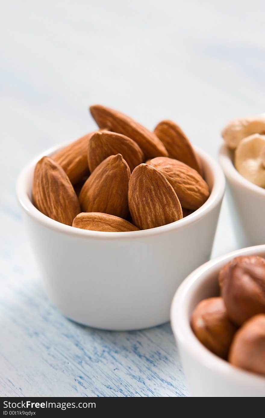 Hazelnut, almonds and acajou in the white dishes. Hazelnut, almonds and acajou in the white dishes