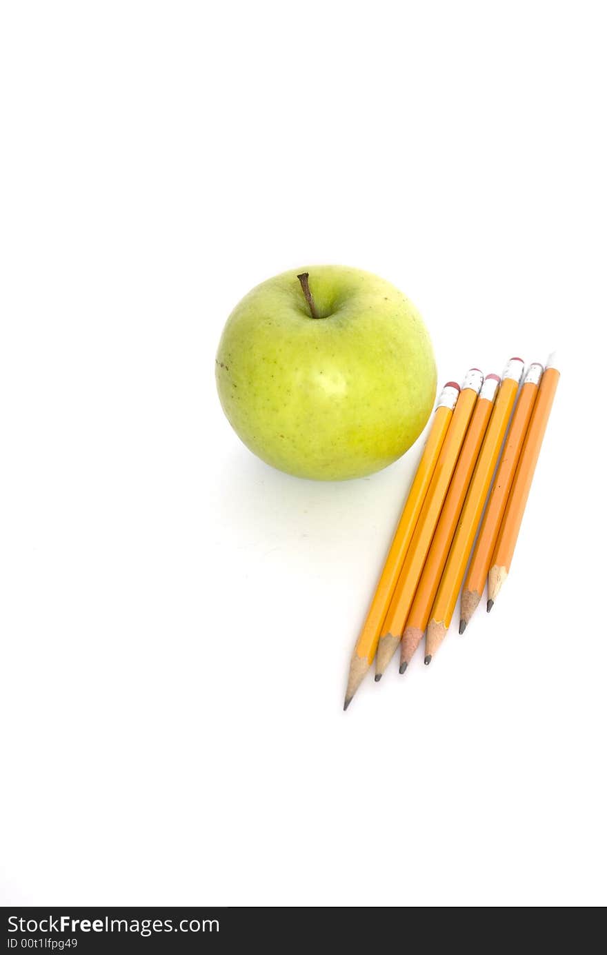 Pencils and apple