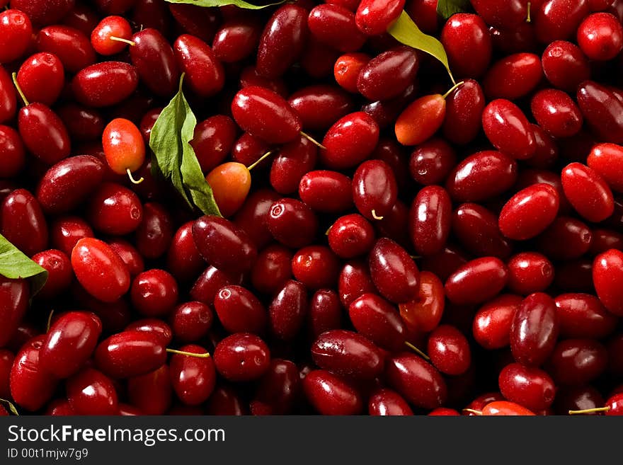 Cornelian cherries, background of nature with liaves