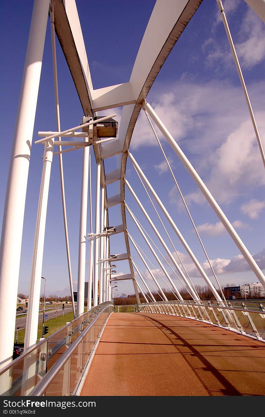 A pedestrian bridge over a highway at a bus station