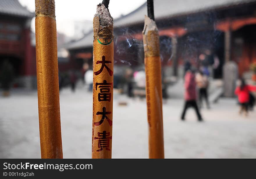 In Chinese,people often go to temple to burn incense to pray for good luck,health,fortune,etc.
the letters on incense means rich,fortune