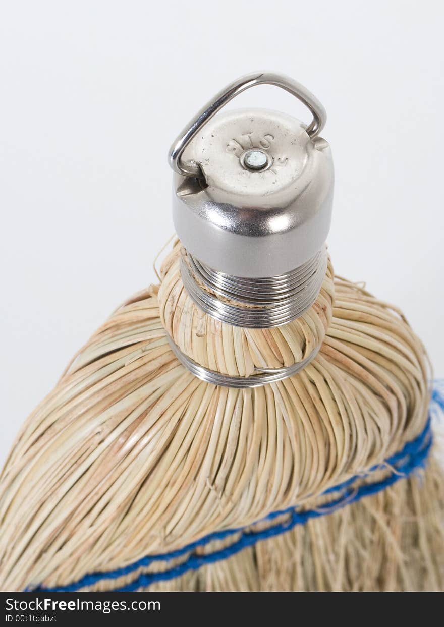 Hand broom handle against white background revealing texture of the straw. Hand broom handle against white background revealing texture of the straw.