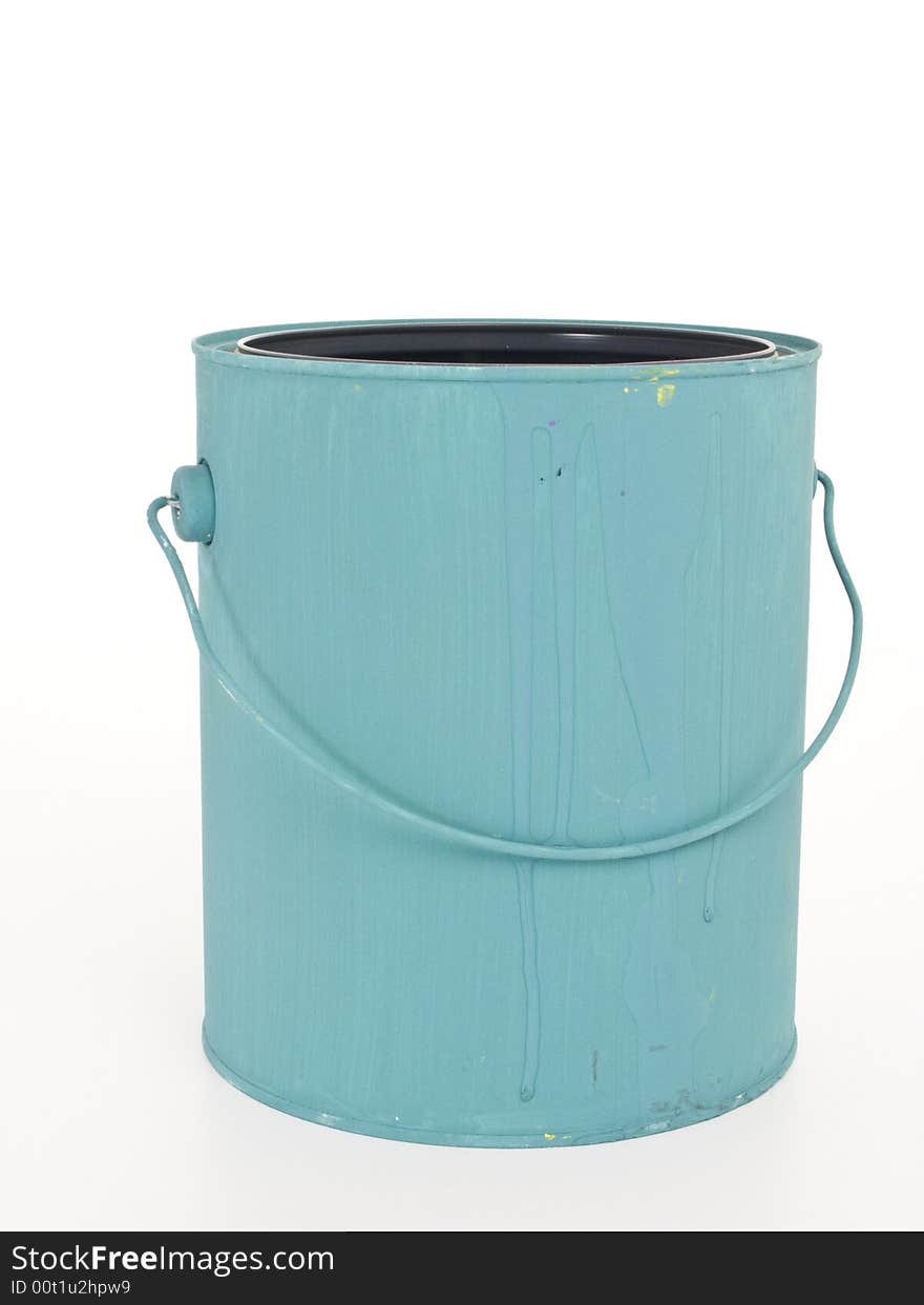 A gallon paint can painted blue with it's lid off on a white background.  T. A gallon paint can painted blue with it's lid off on a white background.  T