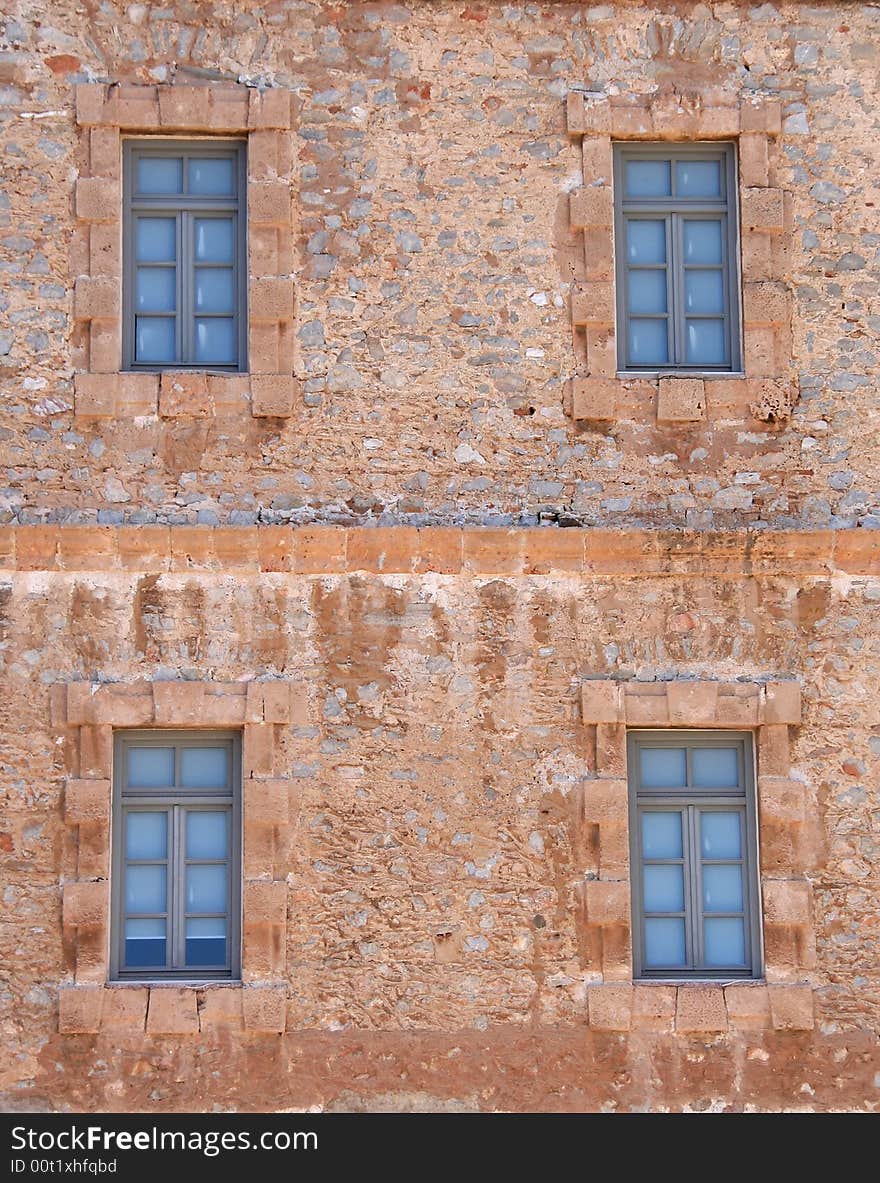 Four windows of an old stone building in the historic city of Nafplio, Greece. Four windows of an old stone building in the historic city of Nafplio, Greece