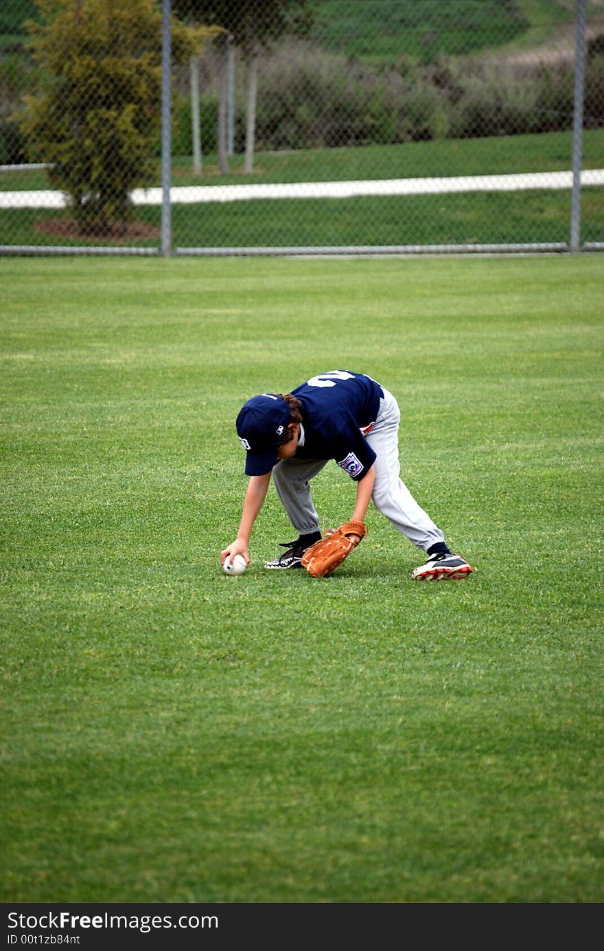 Boy Retrieving A Baseball