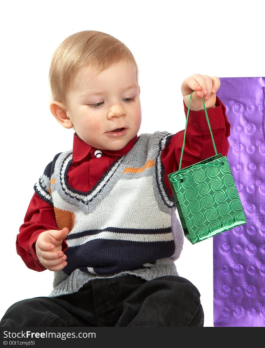 The kid holds a green package