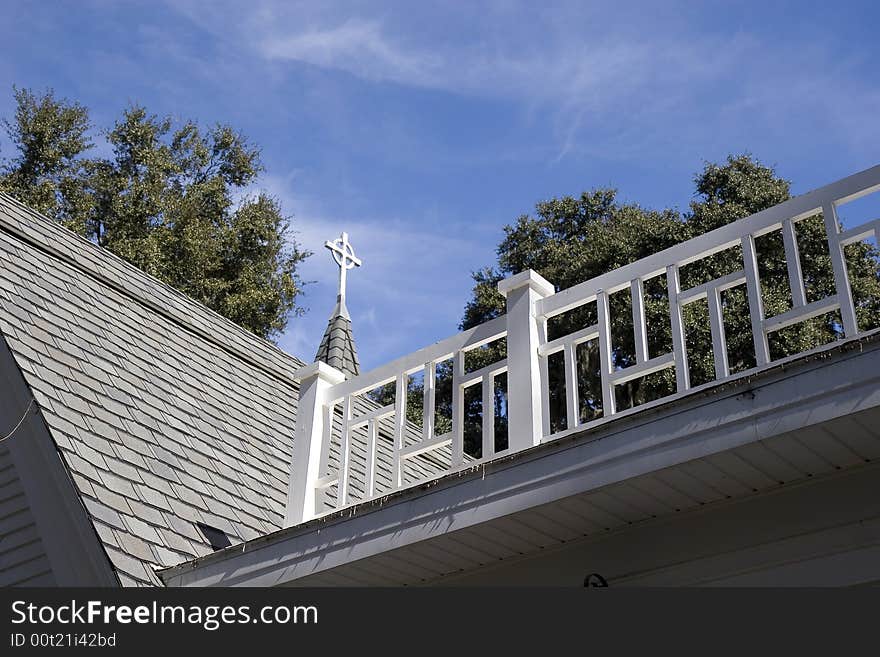 An old church roof with steeple and widows walk