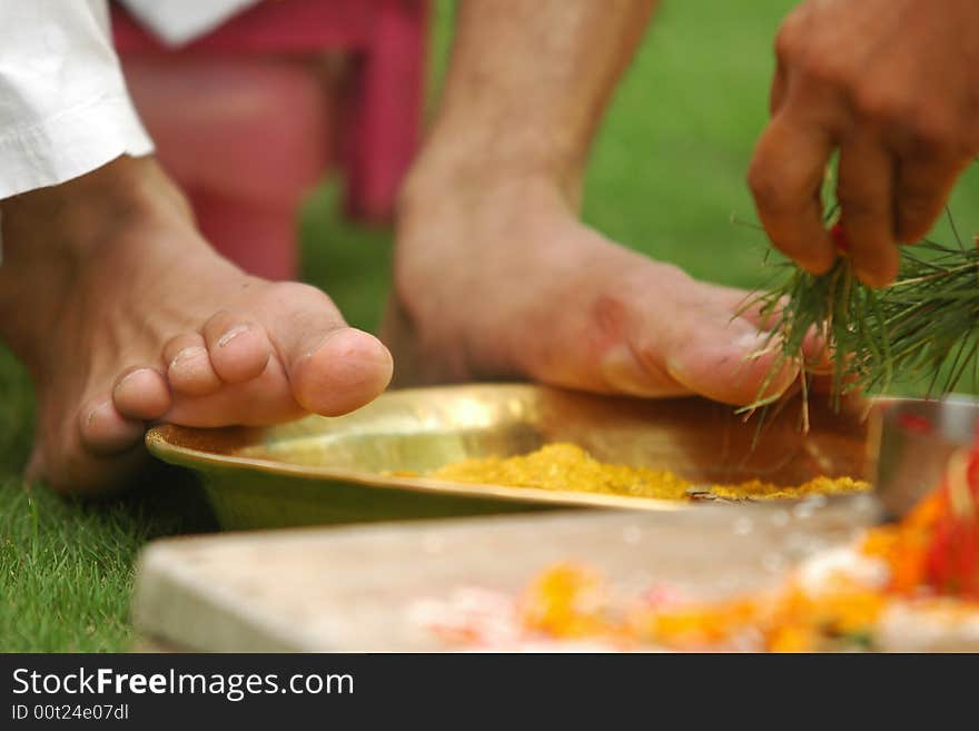 Hindu marriage ceremony. Cleansing of a groom's feet with turmeric. Hindu marriage ceremony. Cleansing of a groom's feet with turmeric.