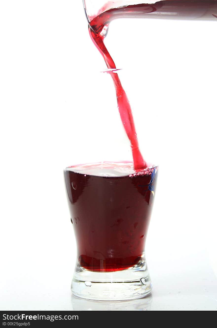 Transparent glass filled with a liquid on a white background. Transparent glass filled with a liquid on a white background