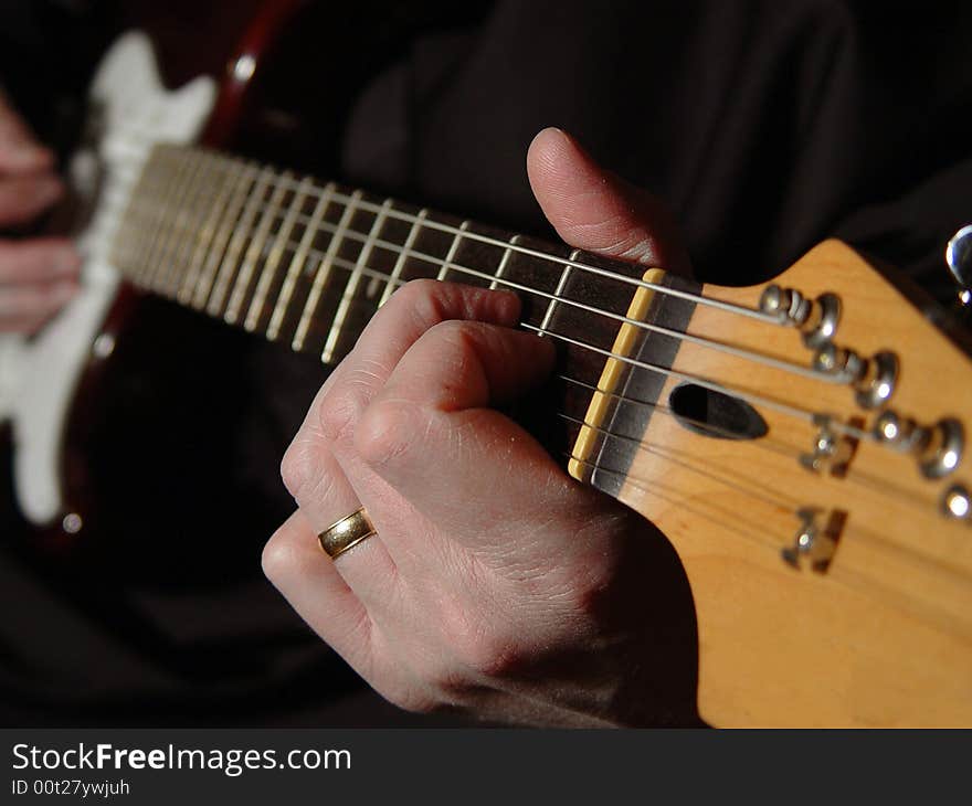 A man playing an electric guitar. A man playing an electric guitar