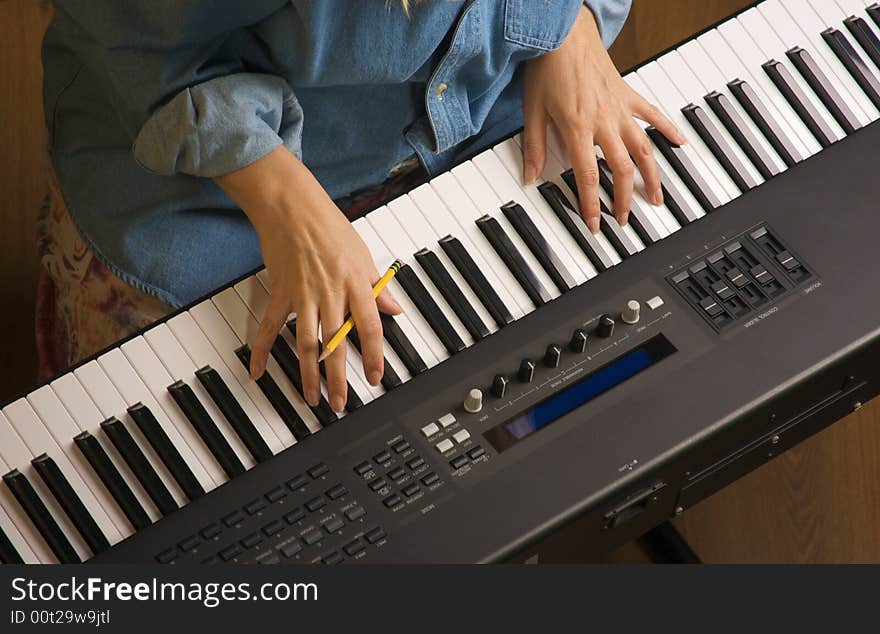 Woman's Fingers with Pencil on Digital Piano Keys. Woman's Fingers with Pencil on Digital Piano Keys