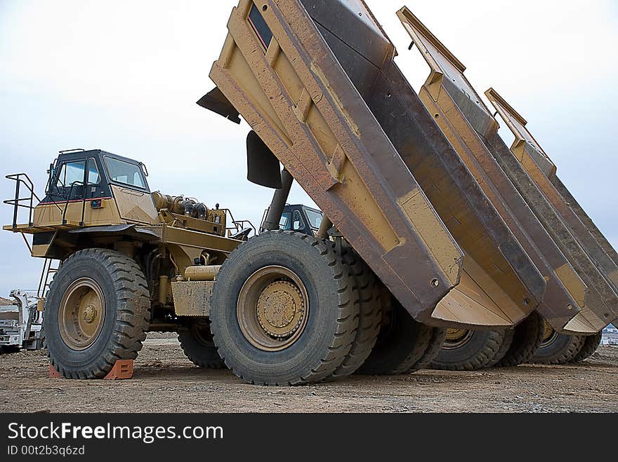 Three dump trucks