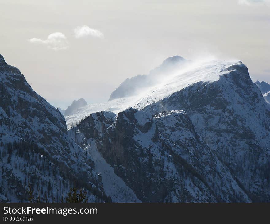 A windstorm is striking mount Civetta on a winter day. A windstorm is striking mount Civetta on a winter day