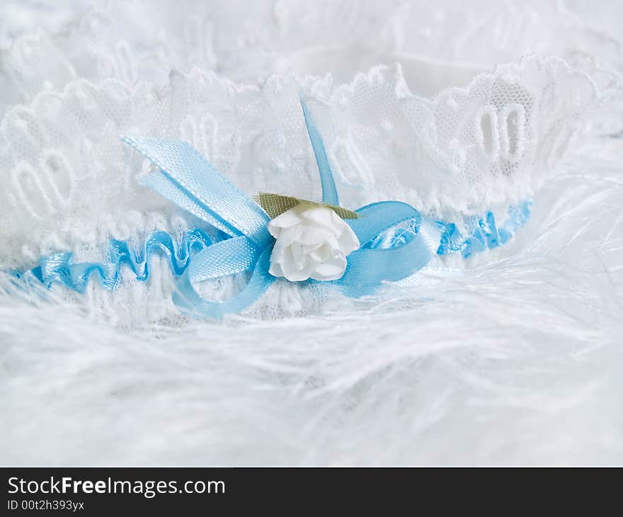 Wedding details. garter with flower and blue laces