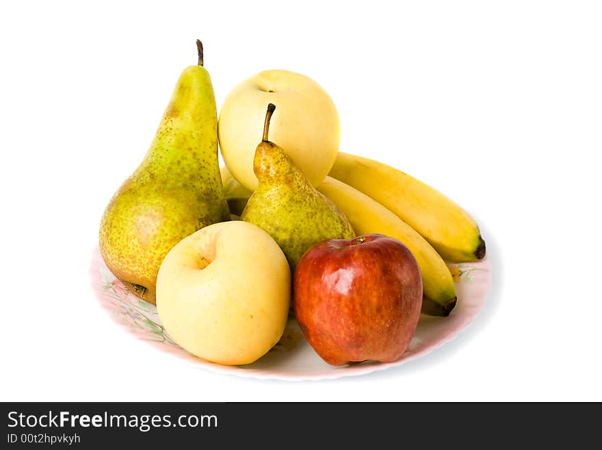 Different fruits laying on the plate isolated with white background. Different fruits laying on the plate isolated with white background