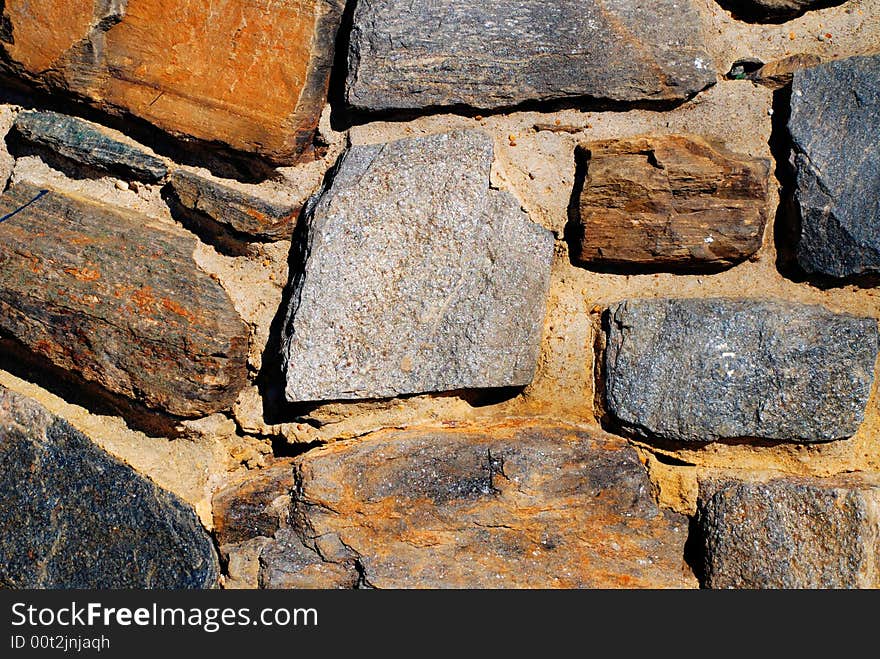 Orange, brown and blue stone wall