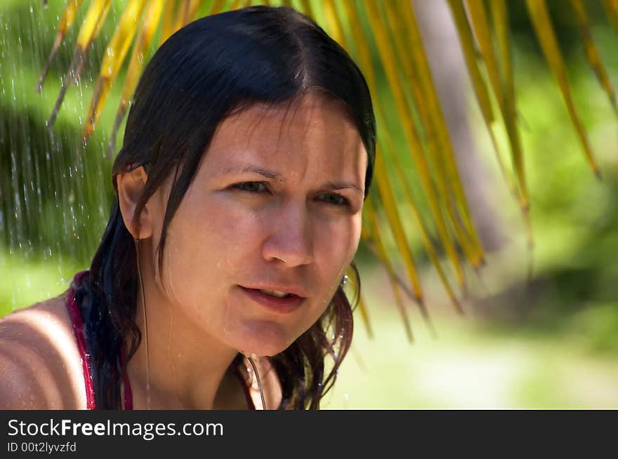 Girl washing in front of palms. Girl washing in front of palms