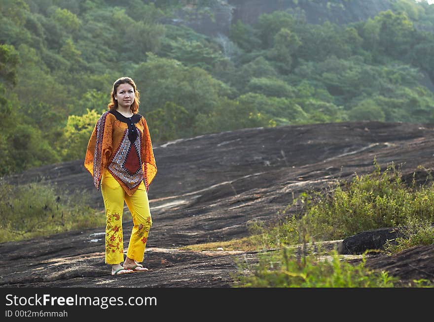 Girl in traditional clothes on the rock. Girl in traditional clothes on the rock