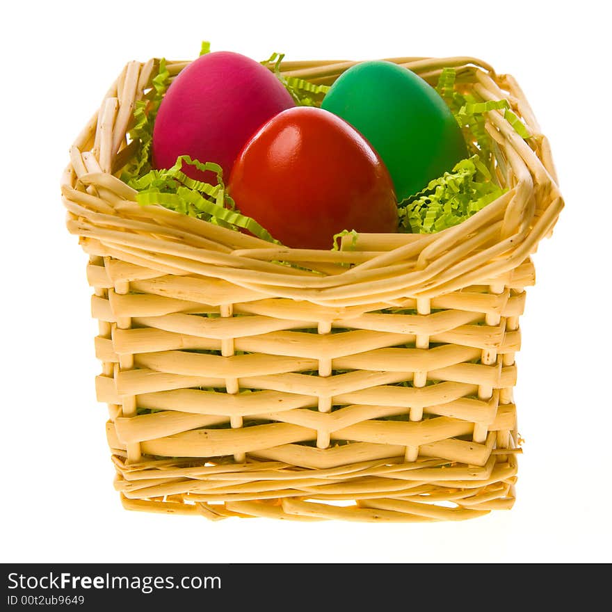 Three multi-coloured Easter eggs in a basket on a white background. Three multi-coloured Easter eggs in a basket on a white background