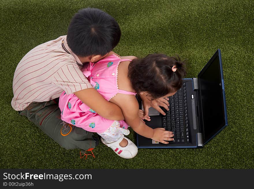 Brother and sister sitting on a garden