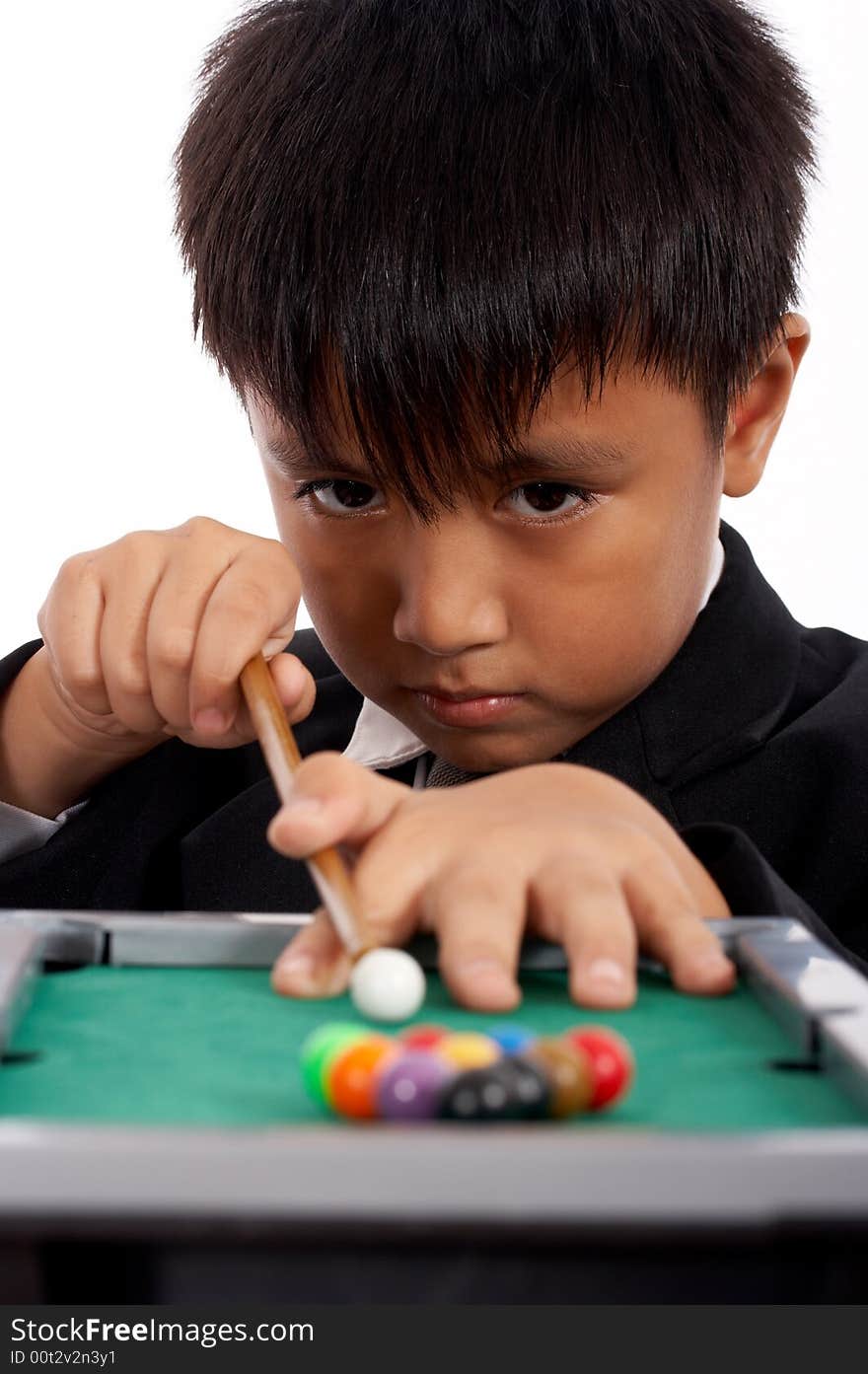 Little boy in black suit playing pool