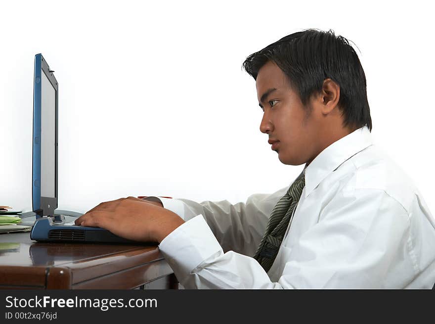 A man working on his laptop over a white background. A man working on his laptop over a white background