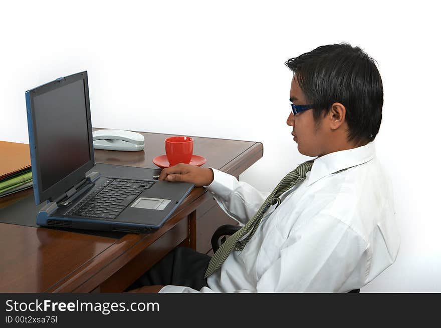 A man working on his laptop over a white background. A man working on his laptop over a white background