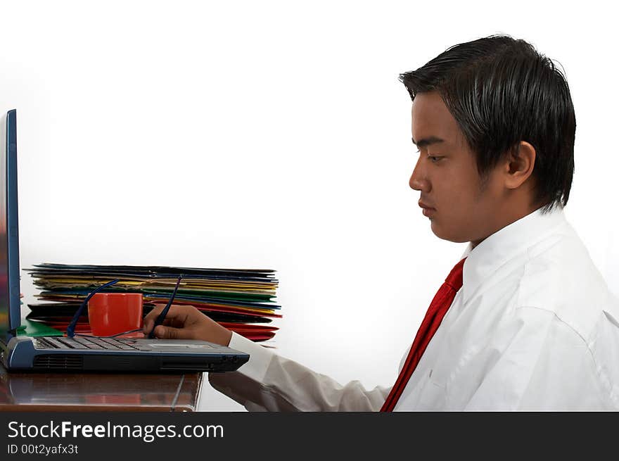 A man working on his laptop over a white background. A man working on his laptop over a white background