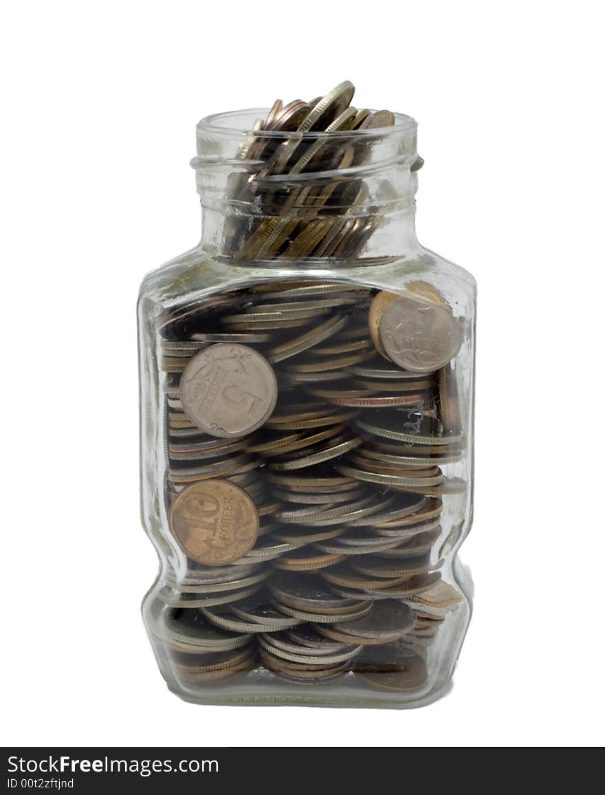 Glass bank with metal coins on white background. Glass bank with metal coins on white background.